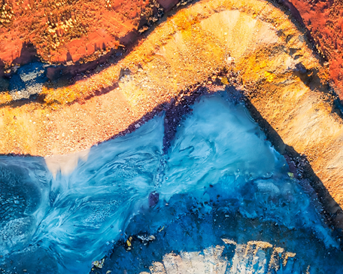 Colourful top down aerial view over open pit mine in Cobar copper town of Outback Australia.