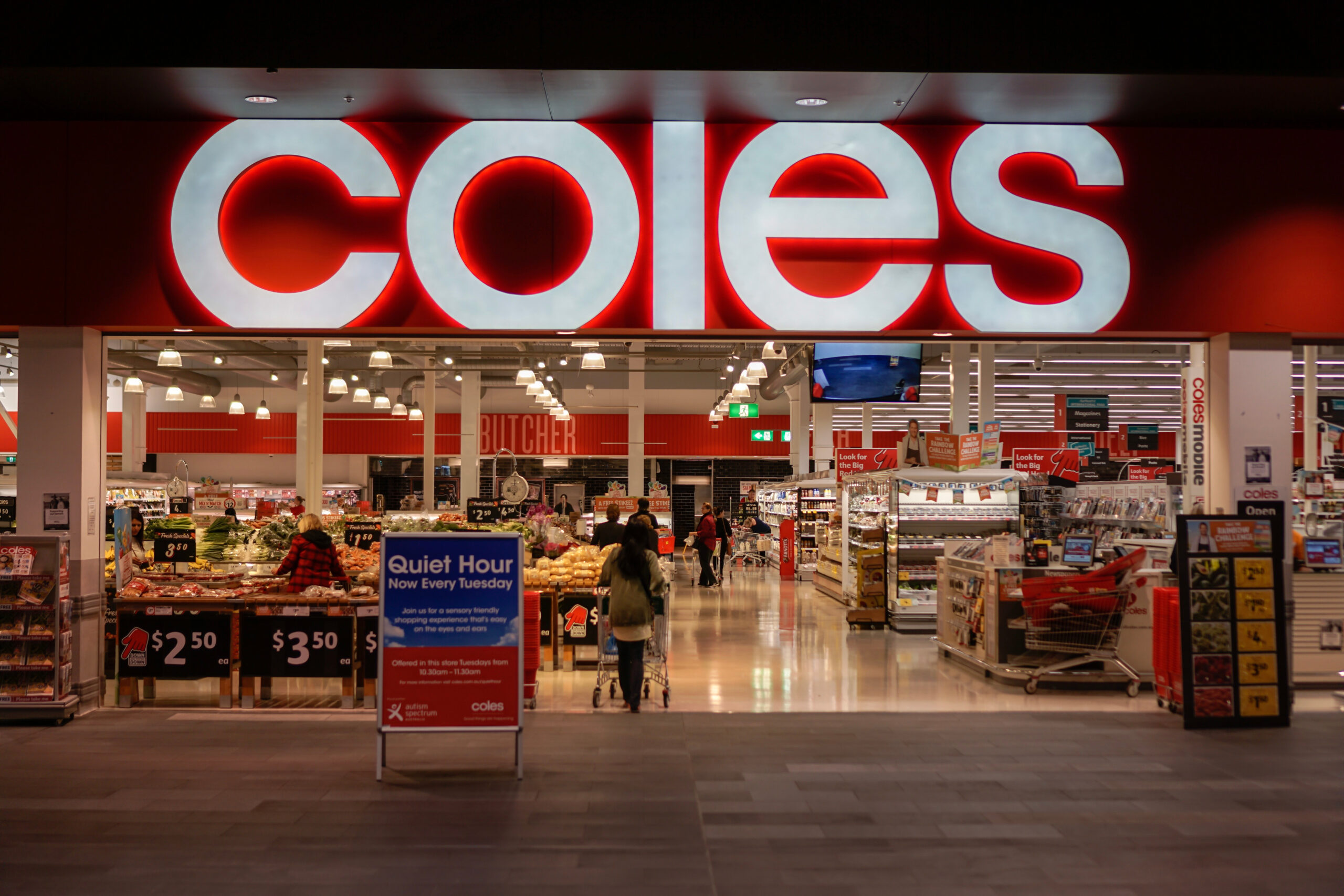 An entryway to Coles supermarket, inside a convenience retail asset, with the logo prominent